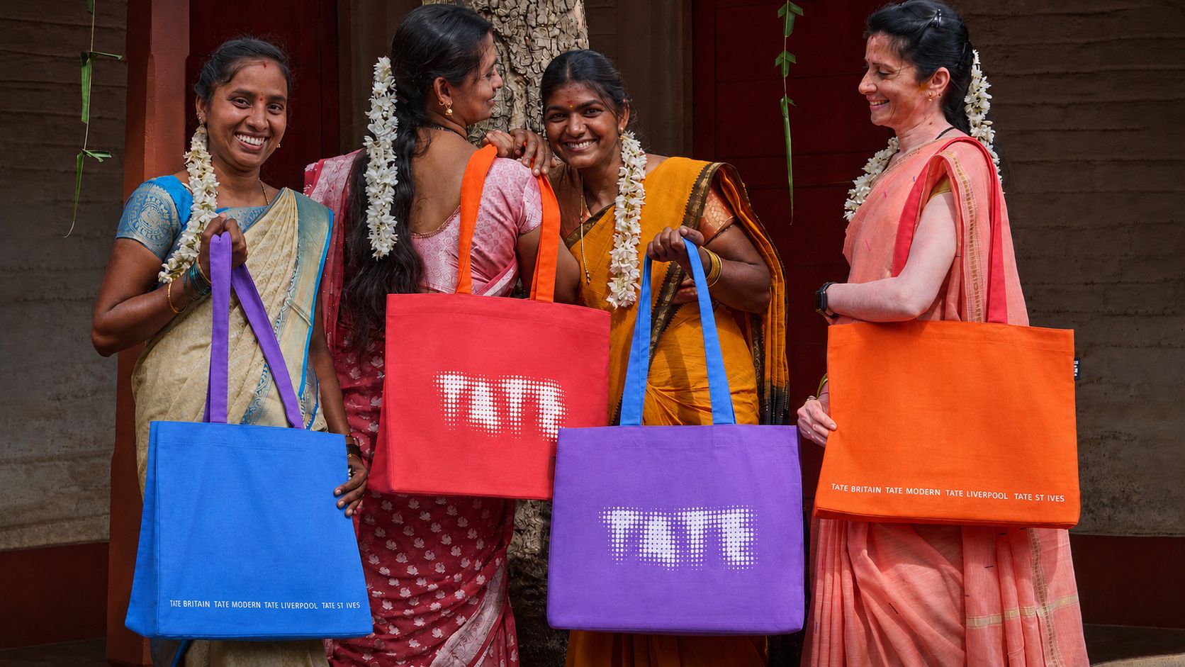 Women smiling and holding bags