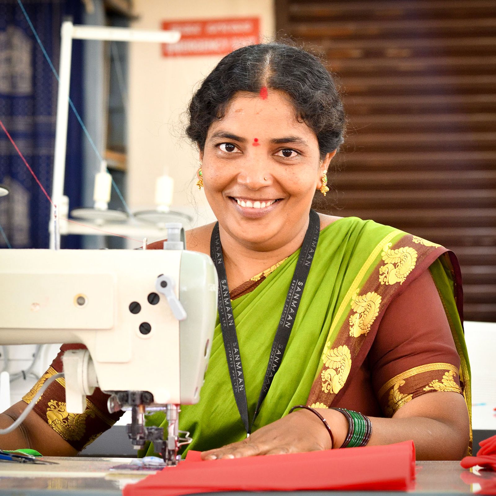 Artisan sewing at machine