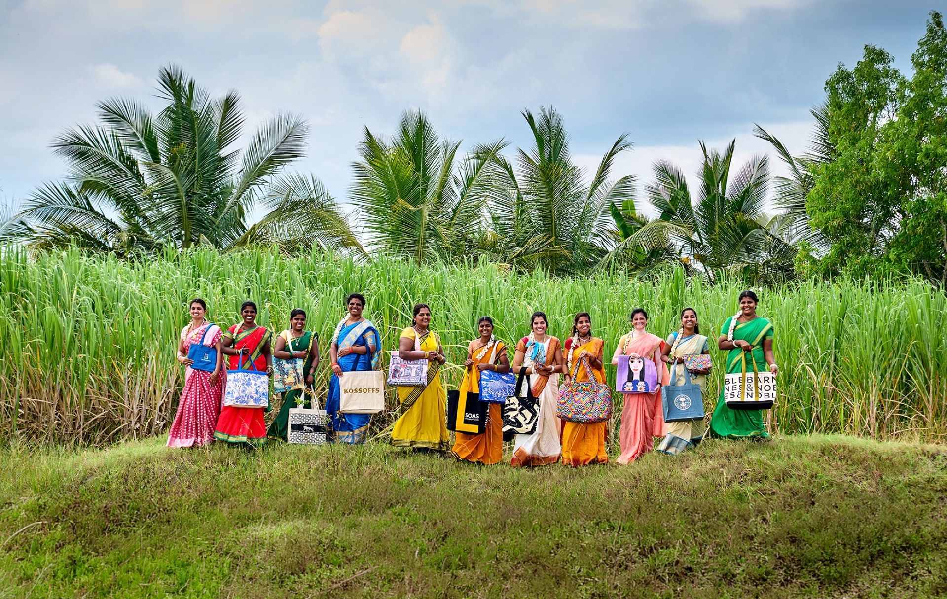 Women in field with tote bags